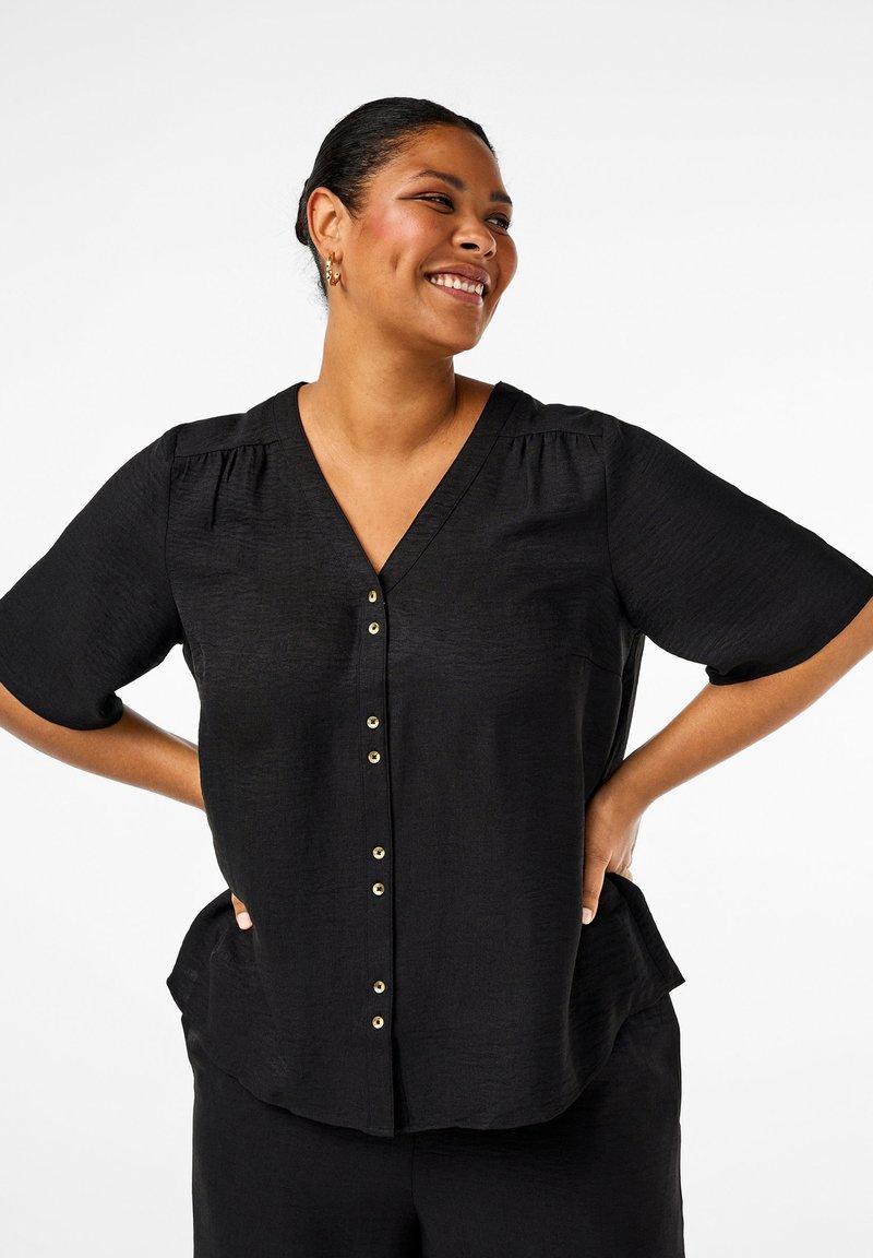 Black v-neck blouse with short sleeves, featuring gold buttons down the front and a textured fabric. Slightly curved hem and relaxed fit.