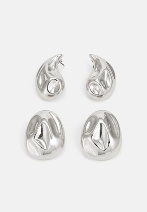 Silver earrings featuring two teardrop shapes and two rounded shapes, all with a polished, reflective surface and smooth texture.