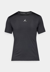 Sort kortærmet træningstrøje med et hvidt Jumpman-logo centralt på brystet og "Jordan Sports" tekst inde i kraven.