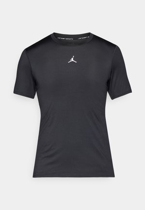 Sort kortærmet træningstrøje med et hvidt Jumpman-logo centralt på brystet og "Jordan Sports" tekst inde i kraven.