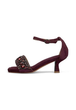Purple suede high-heeled sandal with a bejeweled toe strap and an ankle strap, featuring a slim heel and a textured surface.