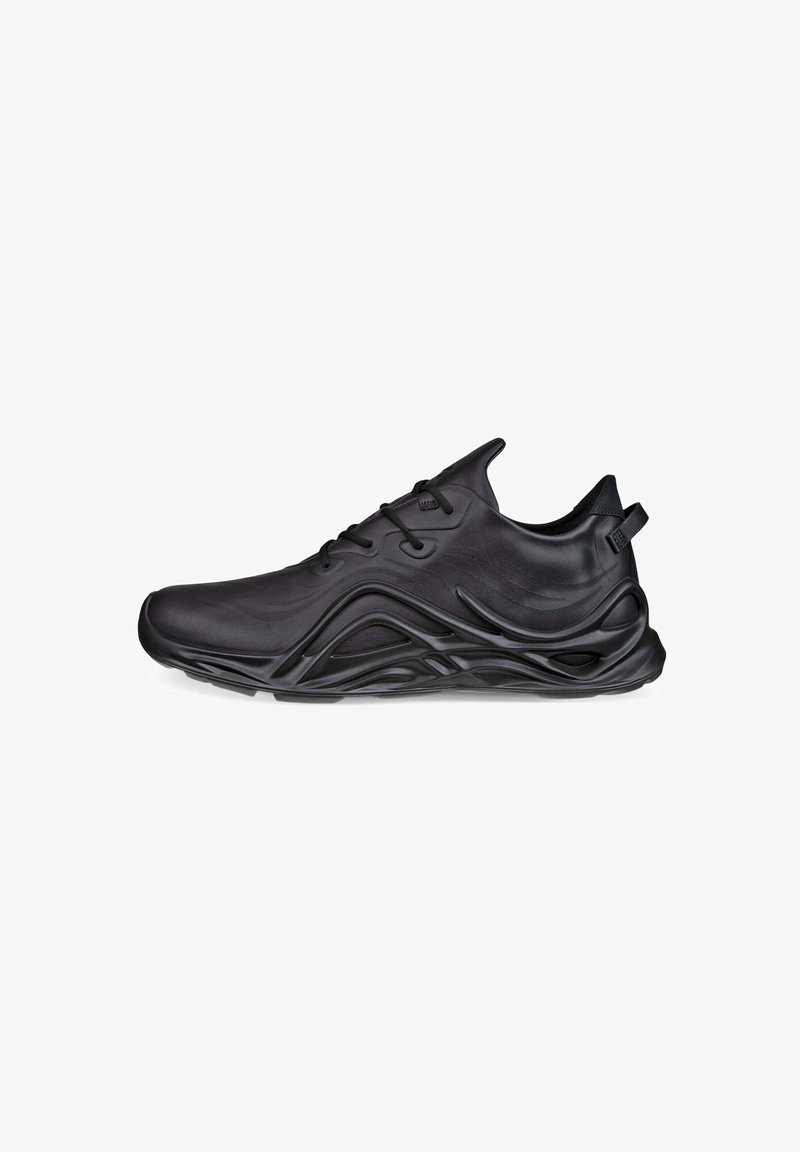 Black athletic shoe featuring a sleek design, textured upper, and a wavy sole with raised accents and textured details.