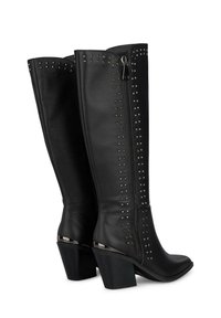 Czarne skórzane wysokie na kolana botki z metalowymi ćwiekami, bocznym zamkiem błyskawicznym, spiczastym noskiem i słupkowym obcasem. Teksturowana powierzchnia zapewniająca przyczepność i styl.