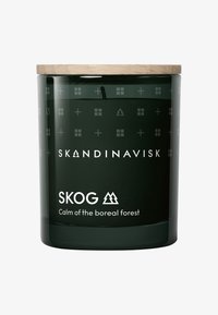 Green glass candle jar with a wooden lid. Features engraved geometric patterns and white text: "SKANDINAVISK SKOG Calm of the boreal forest."