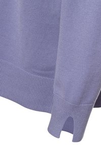 Helllila Pullover mit gerippten Bündchen und seitlichem Schlitzdetail. Hergestellt aus weichem Strickmaterial mit glatter Textur.