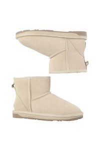 Beige suede ankle boots with a rounded toe, side seams, and a textured rubber sole. Features include a rear pull tab for easy wear.