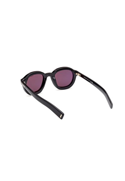 Lunettes de soleil noires avec des verres ronds, teinté dégradé violet et design épuré. Présente des accents dorés sur les charnières et des montures en plastique lisses.