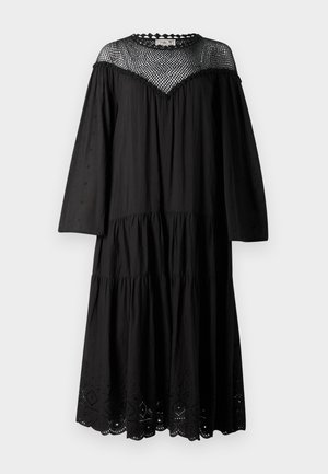 Fekete pamutruha, amely réteges kialakítással, hosszú ujjakkal és hullámos szegélyű hálós betéttel rendelkezik. Lyukacsos díszítés az alján.