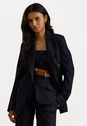 Navy pinstriped blazer with double-breasted buttons, paired with a matching vest and brown belt. Smooth fabric and structured silhouette.