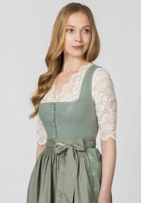 Green dress with a textured bodice, lace sleeves, and a satin skirt featuring floral patterns. Finished with a matching ribbon belt.
