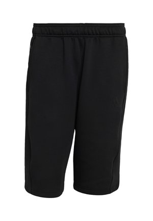 Black athletic shorts made of soft, stretchy fabric. Features an elastic waistband, side pockets, and subtle branding on the lower left leg.