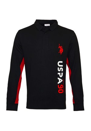 Schwarzes langärmeliges Poloshirt mit roten Seitenpaneelen, rotem Polospieler-Logo auf der Brust und vertikalem weißen und roten Schriftzug "USPA 90" auf der Vorderseite.