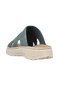 Open-toe slide sandals with a textured teal fabric upper, featuring cut-out details and a lightweight white sole.