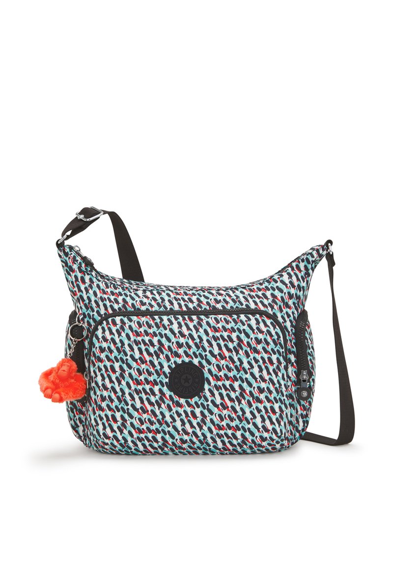 Multicolored fabric shoulder bag with a patterned design, a front zip pocket, and a detachable orange pom-pom keychain.