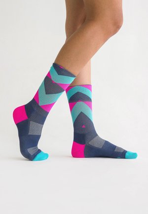 Multicolored socks in blue, pink, and teal with geometric patterns. Features a mix of solid and mesh textures, reaching mid-calf.