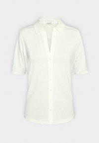 Chemise blanche à manches courtes avec col, dotée d'une patte de boutonnage sur le devant et d'un décolleté en V profond. Tissu doux avec une texture lisse.