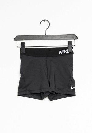 Black athletic shorts with a wide elastic waistband, featuring white Nike branding and a fitted design. Made of smooth, stretchy material.