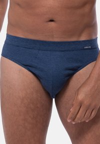 Marineblauwe gestreepte slips met een zachte, elastische tailleband met de merknaam "AMMANN." Glad textuur en een snug fit.