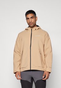 Beige wasserdichte Jacke mit Kapuze, Frontreißverschluss und zwei Seitentaschen. Verfügt über verstellbare Manschetten und ein Logo auf der Brust.