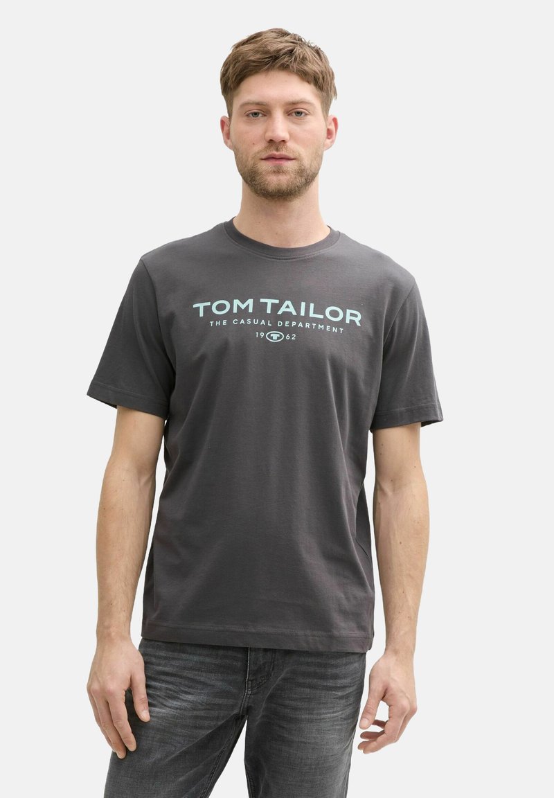 Gray cotton t-shirt featuring a crew neckline and a graphic logo in light blue text on the front. Short sleeves, relaxed fit.