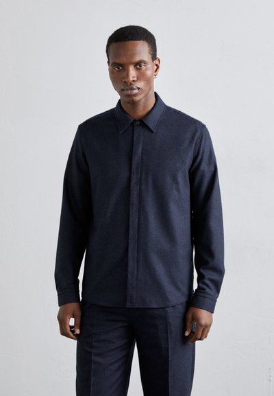 Dark navy button-up shirt with long sleeves, pointed collar, and a smooth texture. Features a single chest pocket and subtle stitching details.