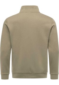 Felpa color khaki chiaro con colletto alto, polsini e orlo a costine, caratterizzata da un ricamo del logo testurizzato sul colletto e una superficie in tessuto liscia.