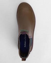 Bota de borracha castanha até ao tornozelo com bico redondo, frente texturizada, forro roxo e uma alça multicolorida. Apresenta um logotipo da marca na lateral.