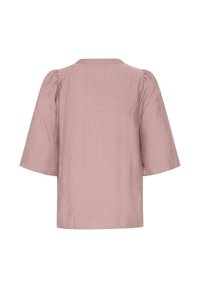 Blouse mauve clair à manches courtes avec épaules légèrement bouffantes et texture subtile, vue de dos sur fond blanc.