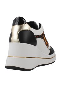 Basket compensée avec un design blanc, noir et imprimé léopard, détails dorés et finition texturée. Dotée d'une semelle plateforme pour plus de hauteur.