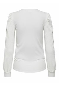 Top bianco con corpo a coste e maniche testurizzate e gonfie. Il design è completato da un collo a giro e polsini aderenti.