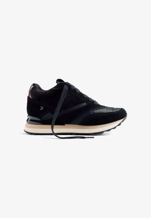 Scarpe da corsa nere realizzate in materiali scamosciati e in pelle, caratterizzate da una finitura testurizzata, punta arrotondata e una suola intermedia di colore crema.