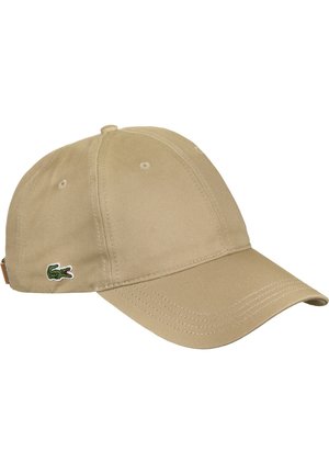 Casquette de baseball en coton beige avec une visière courbée et un petit logo crocodile vert sur le côté.