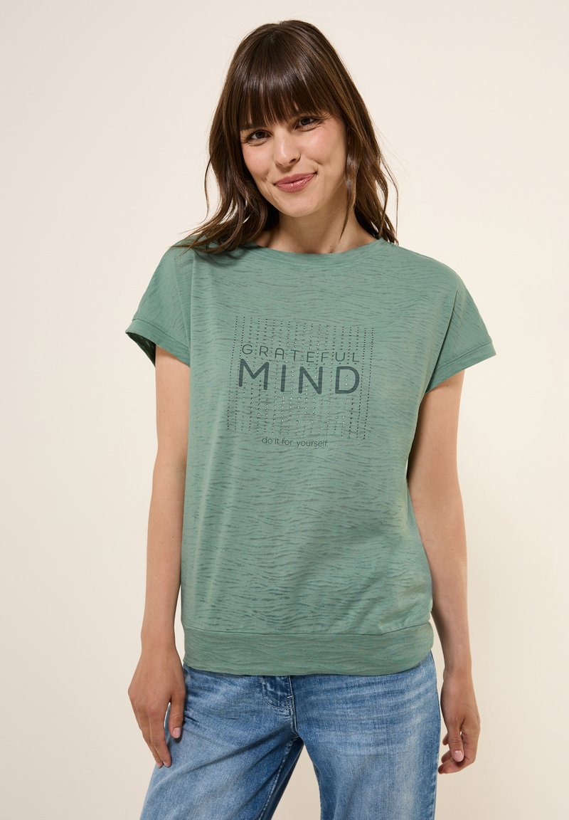 Zelené bavlněné tričko s krátkým rukávem, s potiskem "GRATEFUL MIND" a sloganem pod ním v kontrastní barvě.