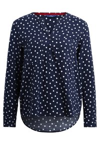 Chemise à manches longues bleu marine avec des pois blancs, dotée d'un col en V, de deux poches poitrine et d'un ourlet incurvé légèrement plus long au dos.