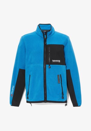 Sininen fleecetakki mustilla yksityiskohdilla, täyden vetoketjun edessä, korkea kaulus ja yksi rintatasku; varustettu Polartec-logolla.