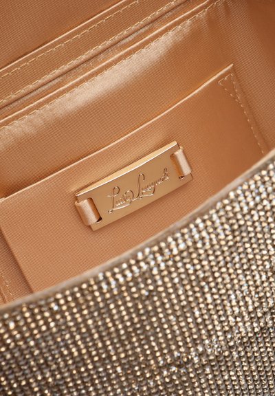 Luxurious gold clutch bag interior with satin lining, small pocket, and metal brand plaque reading "Luisa Spagnoli."