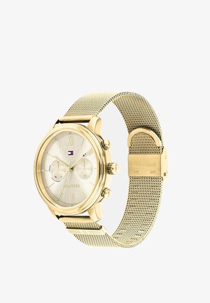Zlatni ručni sat s mrežastim remenom, okruglim brojčanikom s rimskim brojevima, dva podbrojčanika i logotipom Tommy Hilfiger na brojčaniku.