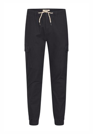 Mustad mustad püksid elastsete mansettidega, nööri vöökoht ja kaks külgmist taskut. Valmistatud vastupidavast kangast, millel on sile tekstuur.