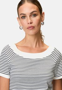 Striped short-sleeve top with a wide white neckline. The fabric features black and white horizontal stripes with a ribbed texture.