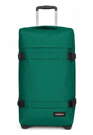 Grüner, weicher Trolley mit Teleskopgriff, seitlichen Kompressionsriemen und Eastpak-Logoaufnäher unten vorne.