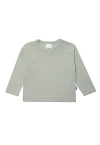 Long-sleeve shirt in soft, light green cotton, featuring a round neckline and two snap buttons on the shoulder for easy dressing.