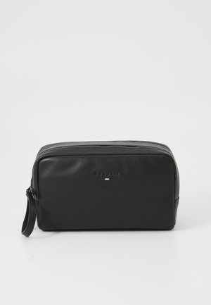 Black leather toiletry bag with a rectangular shape, zip closure, and a handle. Features subtle branding in embossed letters. Smooth texture.