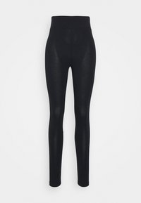 Leggings negros con una textura suave y una cinturilla ancha. Diseñados para un ajuste ceñido, que se estrecha hacia el tobillo. Sin patrones visibles.