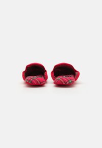 Red fabric slippers with a plaid pattern, featuring rounded toes and open backs, designed for indoor use. Soft texture and flexible shape.