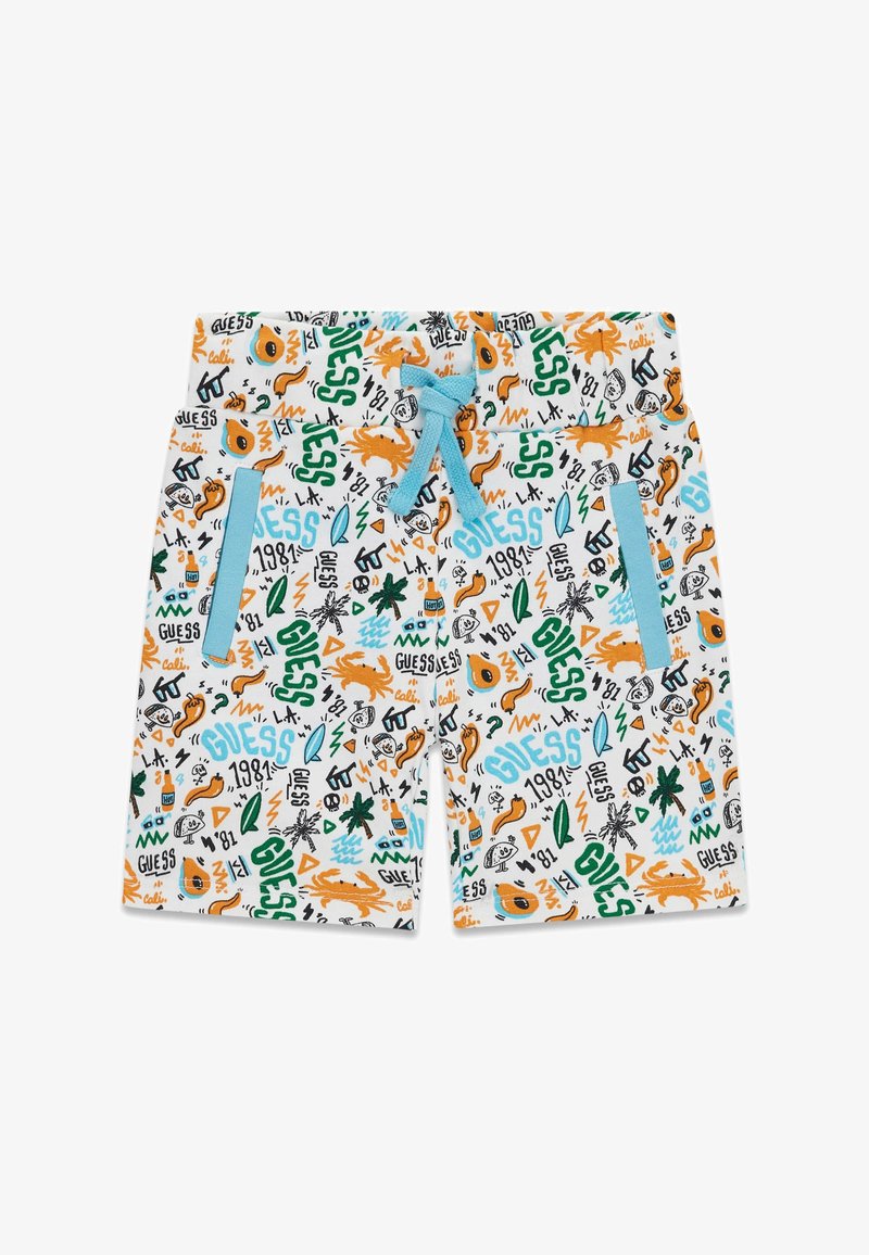 Shorts blancs pour enfants avec cordon bleu, poches bordées de bleu, couverts de griffonnages colorés incluant "GUESS", des crabes, des palmiers et des bouteilles.