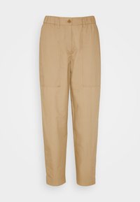 Pantalon léger couleur sable avec une taille élastique, fermeture à boutons devant et deux poches latérales. Texture lisse ; effilé au niveau de la cheville.