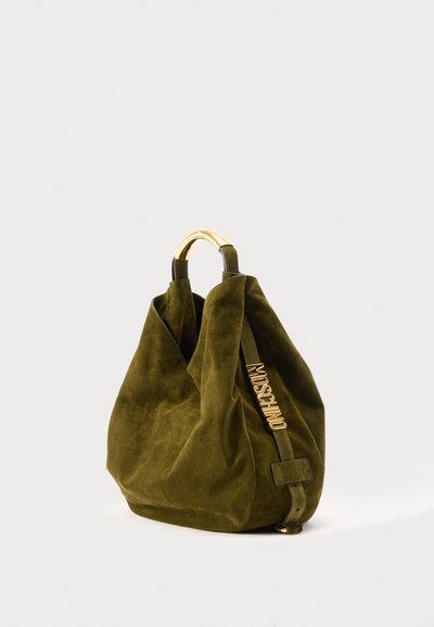 Τσάντα Moschino από σουέτ σε ελιά πράσινο με χρυσούς, στρογγυλεμένους χερούλια και κάθετο χρυσό λογότυπο στο πλαϊνό λουράκι, χαλαρή φόρμα σε λευκό φόντο.