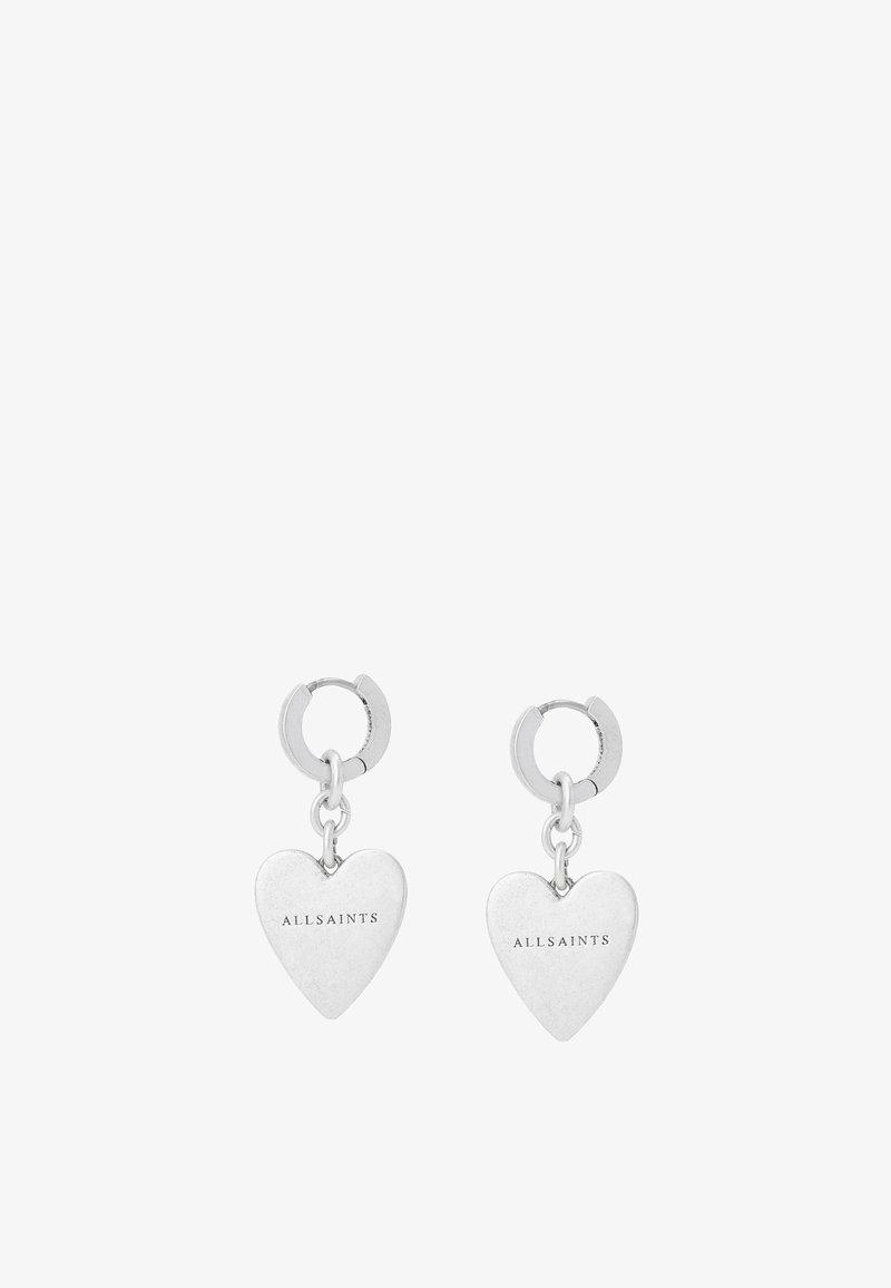 Boucles d'oreilles en forme de cœur argenté avec une finition polie, équipées d'un design suspendu et d'une petite attache en anneau. Nom de la marque "ALLSAINTS" gravé.