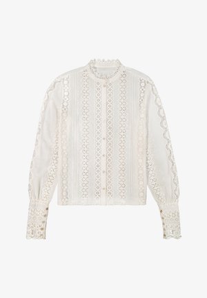 Biała bluzka z długim rękawem z zapinanym na guziki przodem, ozdobiona pionowymi panelami z koronki oraz falbanką z koronki na rękawach, kołnierzyku i mankietach.