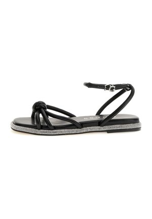 Zwarte platte sandalen met een knoopdesign, verfraaid met een zool met strassteentjes, en voorzien van een slanke enkelband voor een veilige pasvorm.